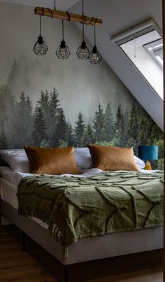 a bed with green sheets and pillows in a bedroom under a slanted ceiling light