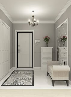 an empty room with white furniture and chandelier