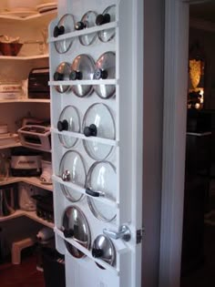 an open refrigerator door with plates and bowls on it