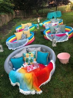 an inflatable couch and table are on the grass with other furniture around it