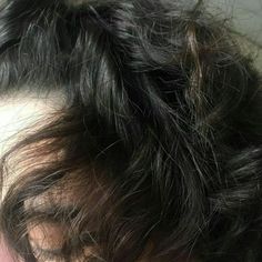 the top part of a person's head with hair in it