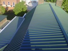 the roof of a building with green shingles