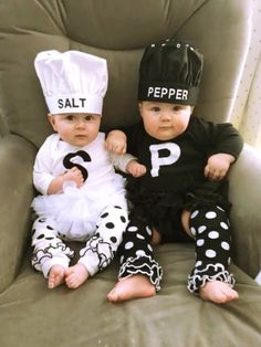 two babies dressed up as salt and pepper sitting next to each other on a chair