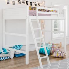 a white bunk bed sitting on top of a wooden floor