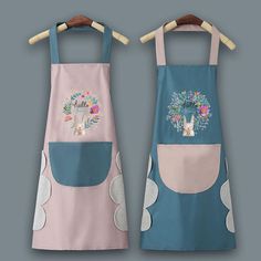 two aprons with designs on them sitting next to each other