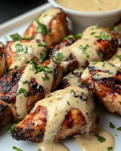 grilled chicken covered in sauce and garnished with parsley