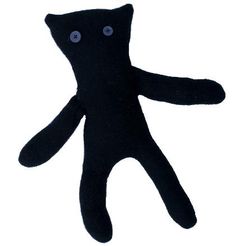 a black stuffed animal with eyes on it's back