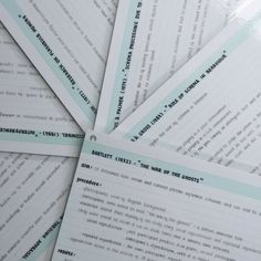 several pieces of paper with words on them sitting next to each other in a pile