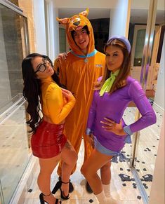 three women are dressed up as scooby and the girl is wearing a dog costume