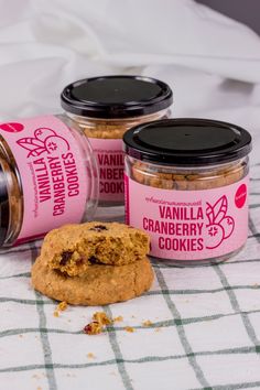 three jars of cookies sitting on top of a table