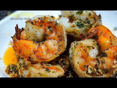 cooked shrimp with herbs and seasoning on a white plate