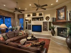 a living room filled with furniture and a flat screen tv mounted to the wall next to a fire place