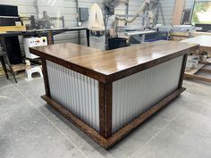 a large wooden table sitting inside of a garage