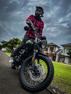 a man wearing a helmet is sitting on a motorcycle