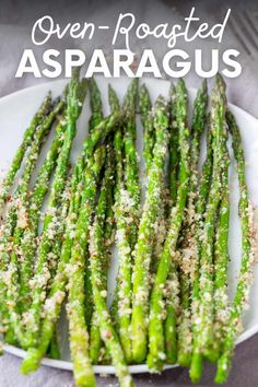 steamed asparagus with pecorino on a white plate