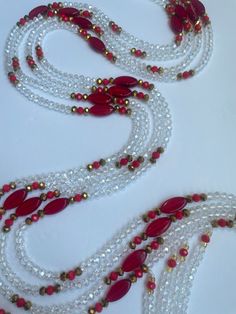 the necklaces are made with red and white beads