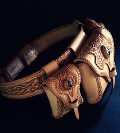 an intricately designed leather belt with turquoise eyes