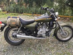 a motorcycle parked on top of a gravel field