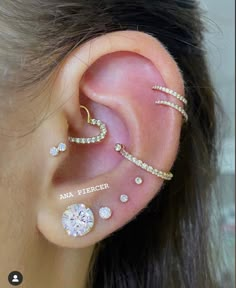 a woman wearing three different ear piercings