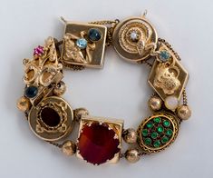 "What a fun find! This colorful and chunky antique Victorian slide bracelet is one that you must add to your eclectic jewelry collection! This little treasure can be dressed up or down and it will draw a little bit of attention from admirers for sure. Antique Bracelet - Antique Victorian 14k & Gold Filled Colorful Gemstone Slide Bracelet Victorian 7 Charms 14k Yellow Gold (1 charm) Gold Filled (6 charms) Carnelian, Blue Zircon, Moonstone, Bloodstone Bracelet measures approximately 7.5\" long 90s Gold Jewelry, Victorian Gold Jeweled Bracelets, Victorian 14k Gold Gemstone Jewelry, Eclectic Jewelry, Fun Jewelry, Victorian Antique Gold Bracelet, Victorian Gold Bracelet Collectible, Luxury Victorian Gold Collectible Bracelet, Chunky Gold Jewelry