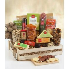 an assortment of gourmet food and snacks in a wooden box on a table