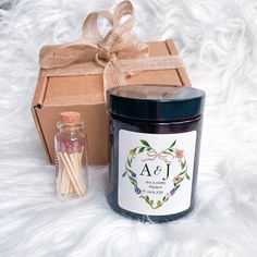 a jar of candles next to a gift box