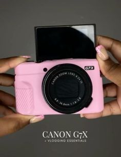 a person holding a pink camera in their hands with the caption canon g7x