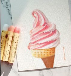 two pencils are next to an ice cream cone