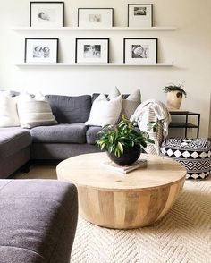 a living room filled with lots of furniture and pictures on the wall above it's coffee table