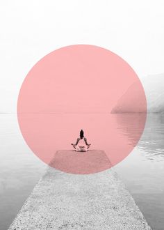 a person sitting on a dock in front of the water with a pink circle around them