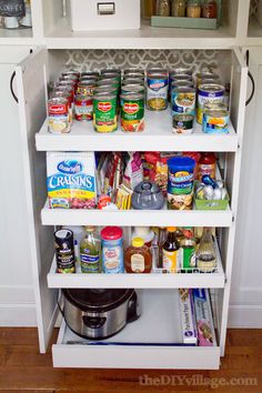 an organized pantry with lots of food and condiments on the bottom shelf,