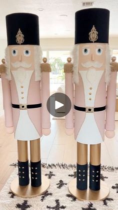 two large nutcrackers standing next to each other on top of a rug