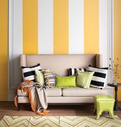 a living room with yellow and white striped walls