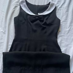 Vintage 90s Does 60s Mod Deadstock Black Tank Dress With Collar. White Collar With Bow Detailing Underneath. Zipper At Back. Original Tags Still Attached. Measurements Taken Lying Flat And Doubled. Bust: 32" Waist: 26" Hips: 34" Total Length: 30 ½" #Goth #90s #Deadstock #Vintage Retro Black Knee-length Mini Dress, Black Retro Knee-length Mini Dress, Fitted Retro Black Mini Dress, Classic Black Dress For Vintage Fashion, Retro Knee-length Mini Dress For Formal Occasions, 60s Dresses Vintage, 60s Goth, 1960s Dresses Vintage, 1960s Style Dress