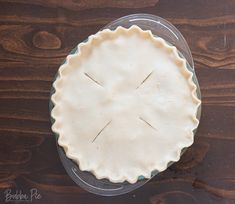 an uncooked pie sitting on top of a wooden table