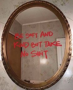 a mirror that has some writing on the side of it with red ink in it