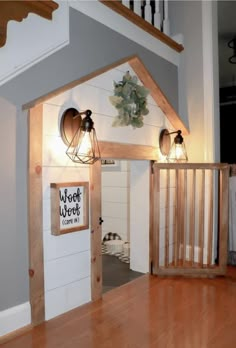 a room with wooden floors and two lights on the wall above it is a dog house