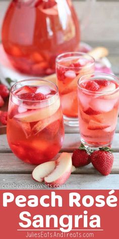 peach rose sangria with sliced apples and strawberries in the pitcher, on a wooden table