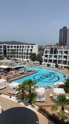 an aerial view of a resort pool and surrounding buildings