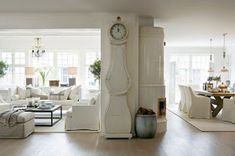 a living room filled with furniture and a large clock on the wall in front of it