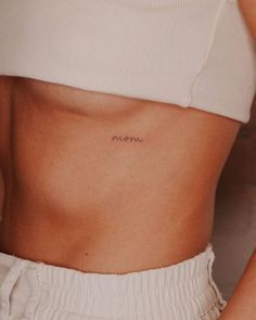 a woman with a small tattoo on her stomach