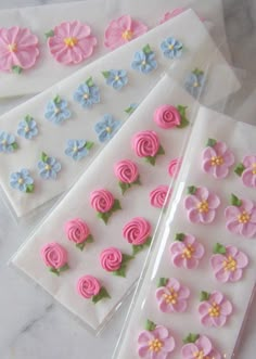 three stickers with pink and blue flowers on them