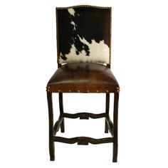 a cow hide back chair with leather seat