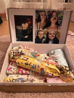 an open box with pictures and wrapping on it