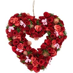 a heart shaped wreath with red and pink flowers