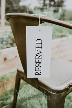 a reserved sign is hanging on a chair