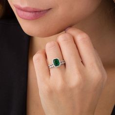 An eye-catching style, this vintage-inspired bridal set matches your bold romance. Crafted in sterling silver, the colorful engagement ring showcases an 8.0 x 6.0mm cushion-cut lab-created verdant-green emerald wrapped in a frame of shimmering petite diamonds - all set atop a glimmering diamond-lined shank. On your wedding day, complete her look with the coordinating band that features a row of alternating marquise-shaped and round frames adorned with sparkling petite diamonds and intricate milg Elegant Green Platinum Jewelry, Platinum Jewelry With Green Diamond Accents, Timeless Cubic Zirconia Emerald Wedding Ring, Silver Princess Cut Emerald Ring For Wedding, Dazzling Wedding Emerald Ring In Platinum, Wedding Jewelry In Platinum With Emerald Cut, Platinum Emerald Ring With Accent Stones For Wedding, Wedding Emerald Ring With Accent Stones In Platinum, Wedding Jewelry Platinum With Emerald Cut