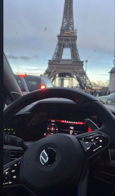 the interior of a car in front of the eiffel tower