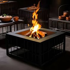 a fire pit sitting in the middle of a room filled with plates and bowls on top of it