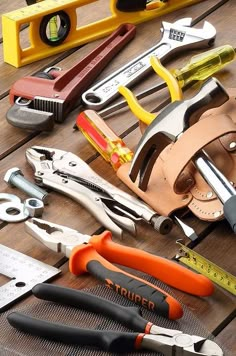 various tools are laid out on a wooden table